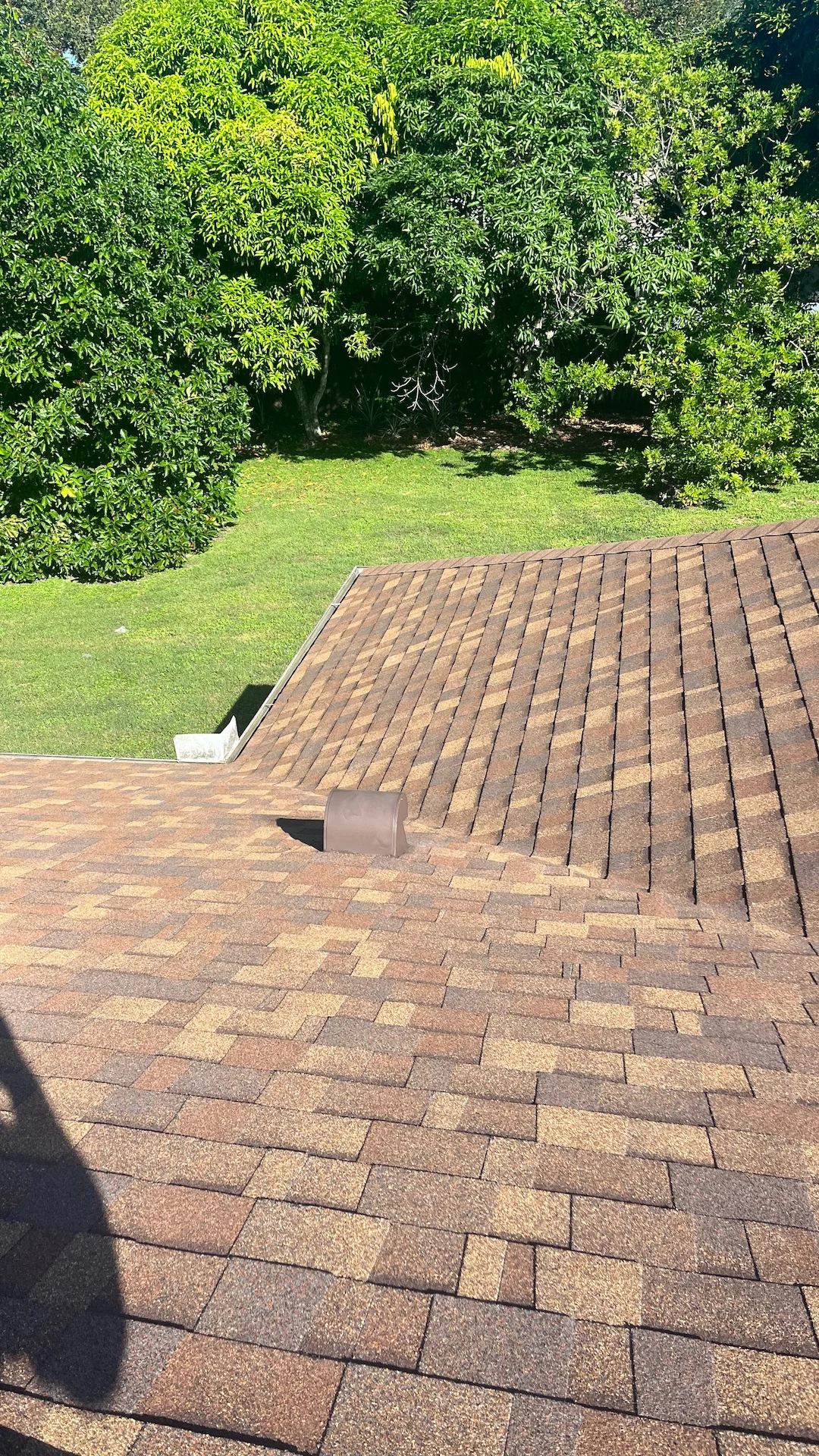 Properly installed asphalt shingle roof with a ventilation unit in Rockledge, FL.