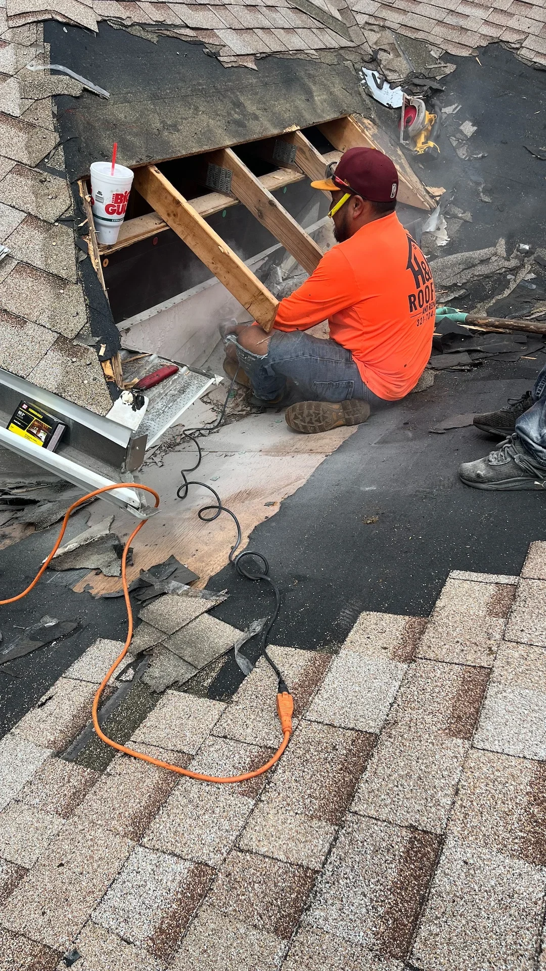 Skilled roofer performing an asphalt shingle repair on a residential home in Rockledge.